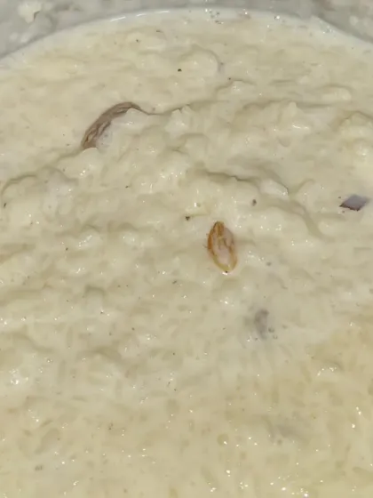 A bowl of our homemade style Kheer, a creamy rice pudding cooked with milk, sugar, and dry fruits.