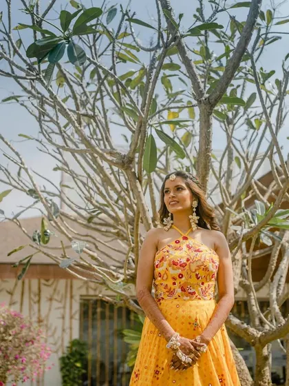 The beautiful bride shining in her yellow outfit for the Haldi ceremony. We help style the event to make our clients look and feel their best.