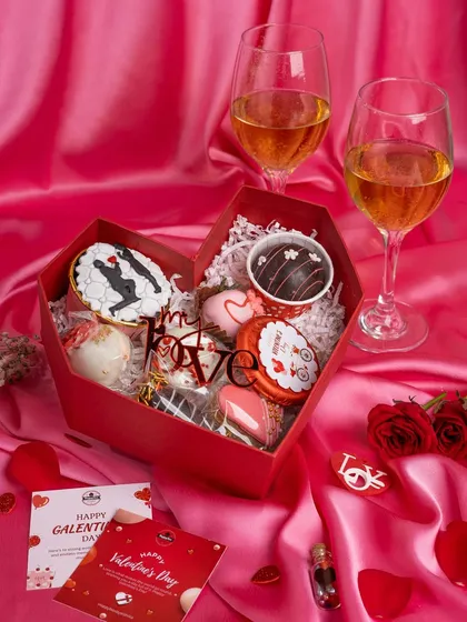 Love is in the details. This Valentine's Day hamper shot was styled with soft, silky fabric and wine glasses to create a romantic and indulgent mood, perfect for a special gift.