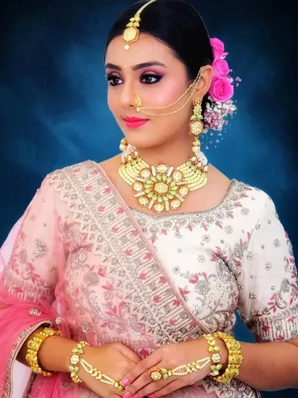 Another view of the client's stunning bridal look. The floral bun adds a touch of romance and tradition to her modern makeup.