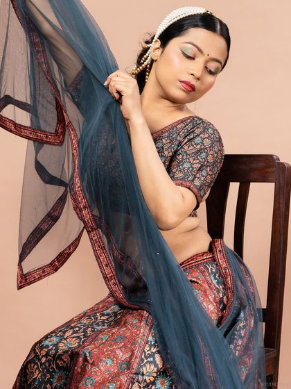 An artistic pose with the dupatta, creating a graceful and flowing composition.