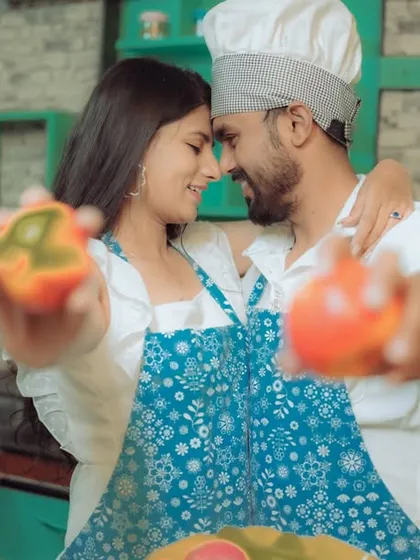 Love is cooking up something beautiful! This couple shares a laugh in a quirky kitchen setting, a perfect example of a themed pre-wedding shoot that reflects shared interests and creates fun, natural interactions.