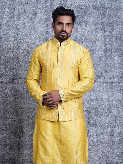 A frontal view of the canary yellow bundi set. The bright, cheerful color combined with the subtle texture of the pintuck kurta makes for a memorable and festive ensemble.