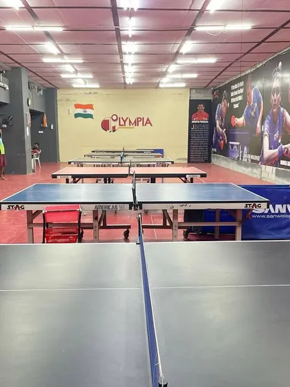 A view from the front of the academy, showcasing our professional tables and the iconic JP Olympia logo against the wall. This is where your journey begins.