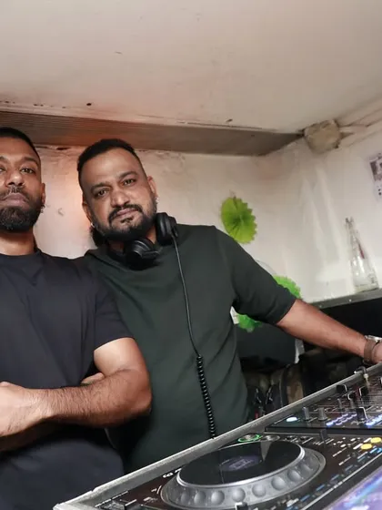 Behind the scenes at the DJ booth with a fellow artist. We're a team, working together to create the perfect atmosphere for the night.