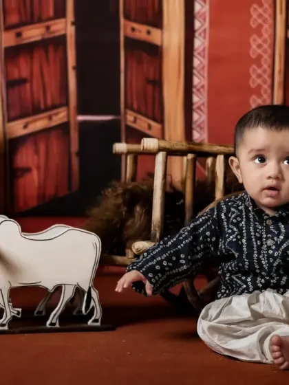 A seated portrait of a baby boy in our traditional village setup.