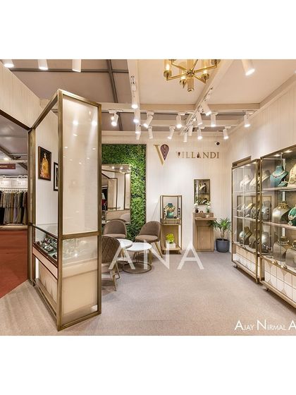 A dedicated seating area within the Villandi stall provides a comfortable space for private consultations. A green wall adds a touch of nature and texture, enhancing the luxurious and calm atmosphere.