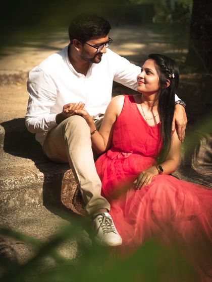 Seated on stone steps, this couple shares a look. I framed this shot through some foliage to add depth and create the feeling of peeking into a private, romantic moment.