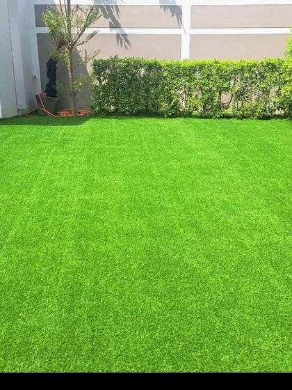 A simple, clean backyard lawn created with high quality artificial grass. I ensure the installation is seamless for a natural look that enhances your garden.