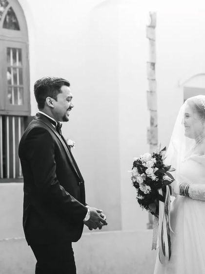 The groom turns to see his bride for the first time. His initial reaction is captured in this candid black and white photograph.