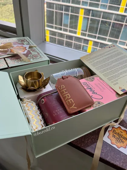 A personalized Diwali hamper featuring a custom name-engraved luggage tag and water bottle. This level of personalization makes every recipient feel truly special.