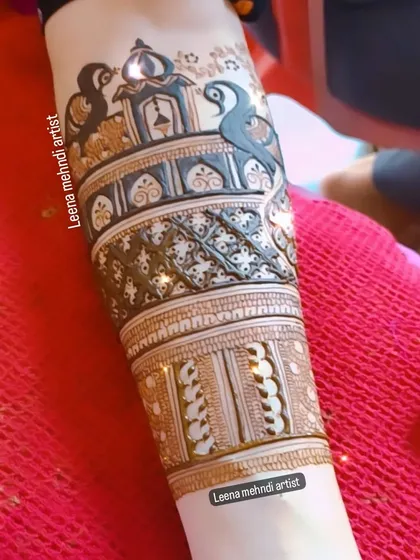 A heavy start-up design perfect for a festival like Teej. It features architectural domes and peacocks, creating a rich and celebratory look on the forearm.