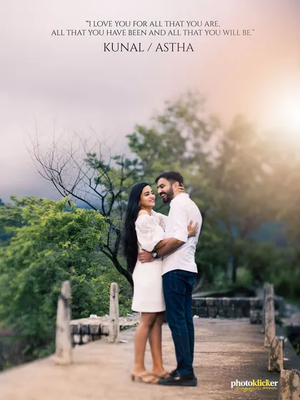 A classic romantic pose on a bridge surrounded by nature. This pre-wedding shot captures a feeling of journey and togetherness against a soft, golden-hour sky.