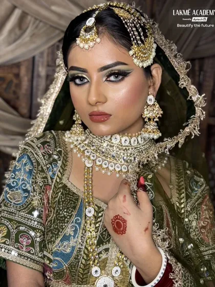 Another powerful shot of the Arabic bridal makeup. This highlights the sharp contouring and the intricate headpiece, showcasing our student's skill in creating a high-impact, culturally rich look.