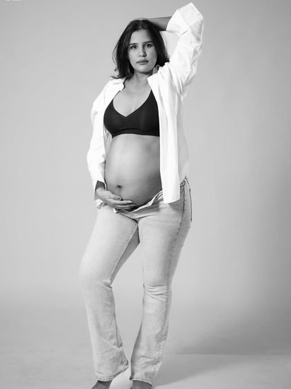 This black and white pose is confident and relaxed. It captures a natural moment, creating a portrait that feels both artistic and authentic.