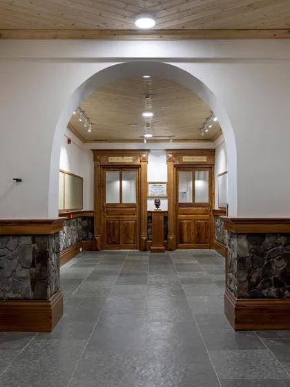The renovated hallway outside the labs, where we exposed the original stone and added warm wood wainscoting to create a cohesive and welcoming circulation space.