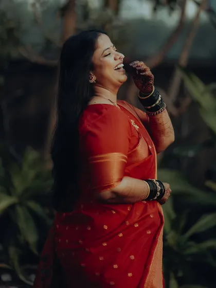 A moment of pure, uninhibited laughter. This candid shot of Neelam in her beautiful red saree shows the joy that love brings.