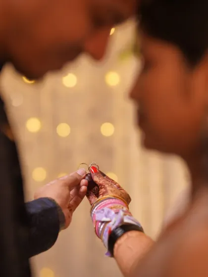 A beautifully detailed close-up of the ring exchange during an engagement ceremony. Capturing this pivotal moment is a key part of our ring ceremony photography service.