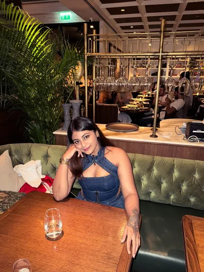 Posing at the dinner table. The all-denim outfit creates a strong, cohesive look that's both casual and fashionable.