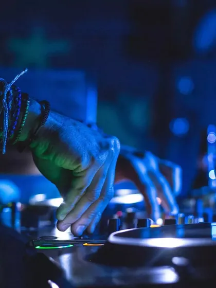 A close-up of the craft. Every beat, every transition is mixed live to create a seamless musical journey. This is where the magic happens, blending tracks to keep the party going all night long.