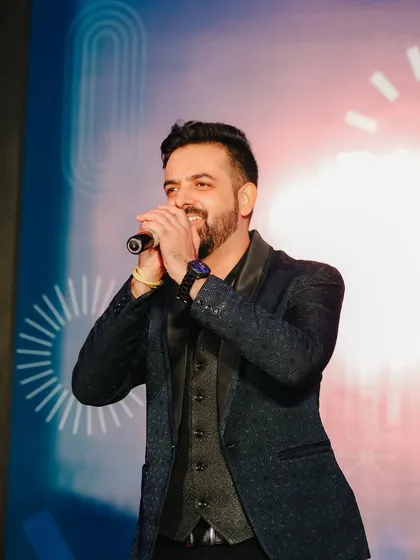 A candid shot of me singing and hosting at the 'One Applied' Family Day for Applied Materials.