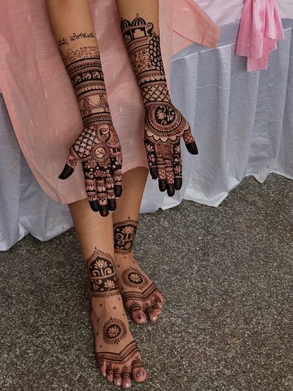 A beautiful shot capturing both the hand and foot mehendi, showcasing a cohesive and complete bridal look.