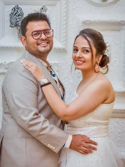 A classic, smiling portrait of an engaged couple. Their comfortable pose and happy expressions make for a timeless and beautiful memory of their celebration.