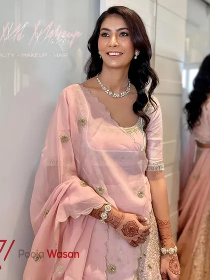 Another angle of this refined and elegant look. The reflection in the mirror shows the beautiful flow of the hair and the soft silhouette of the lehenga.