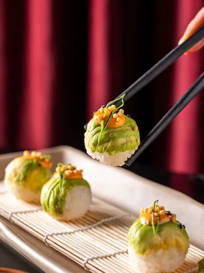 Another view of our Avocado Temari Sushi, showcasing the beautiful spherical shape and the creamy avocado wrapping. A true party starter.