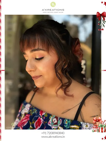 A playful Christmas glam look featuring retro curls, bangs, and a soft pink shimmer on the eyes.