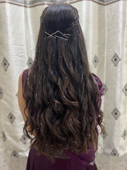 A full back view of this intricate and elegant half-up, half-down hairstyle, perfect for a reception or engagement.