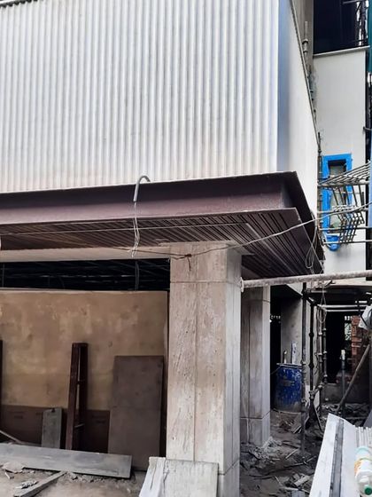 The evolution of a facade under construction. Here, the structural steel beams and corrugated metal decking are in place, forming the base for the final exterior cladding.