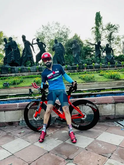 Posing with his red Trek Speed Concept triathlon bike.