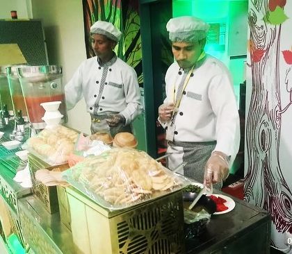 Our chefs in uniform, ready to serve guests at a corporate event's live chaat station, ensuring both taste and hygiene.