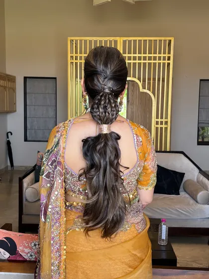 The full view of the modern braided ponytail. This hairstyle is perfect for a Sangeet or reception, combining the elegance of a braid with the fun of a ponytail.
