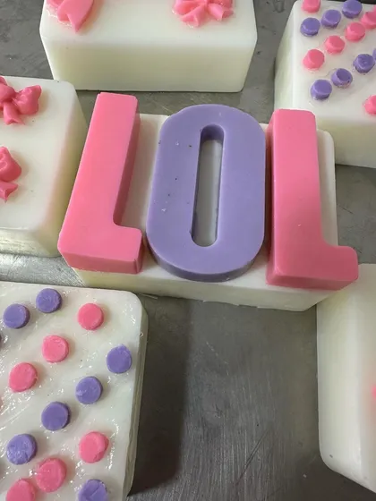 A close-up of the 'LOL' soap, a popular choice for themed birthday party favors.