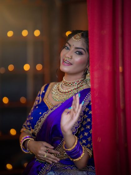 A playful peek from behind a curtain. The eye makeup is the focus here, with a beautiful blend of colors that catches the light.
