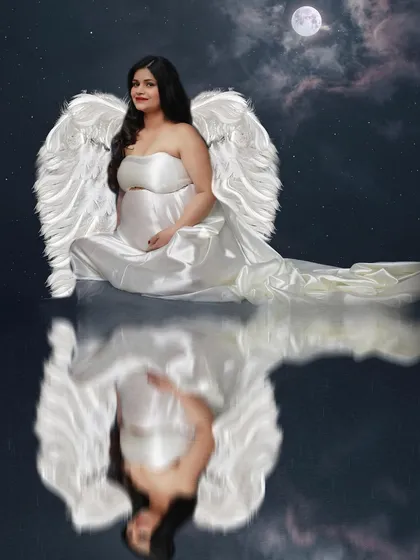 A fairy tale series. This portrait with satin angel wings and a moonlit reflection creates a magical, dreamlike image of the mom-to-be.