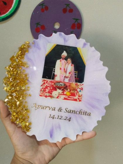 Holding the personalized wedding frame to show its size and the beautiful texture of the golden crystals along the edge.