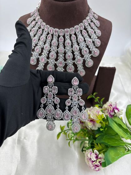A magnificent, full-coverage AD necklace set designed for grand events. The intricate web of American Diamonds creates a dazzling effect, perfect for bridal and reception wear.