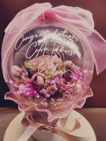 Another one of our congratulatory blooming acrylic bubble balloons, this one in pink for CA Khushi. It's a beautiful and modern way to celebrate a major professional achievement.