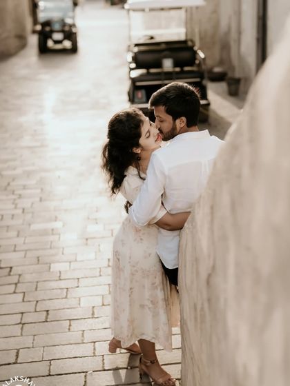 A stolen kiss in a quiet, sunlit alleyway, capturing a private and romantic moment during the Dubai pre-wedding shoot.