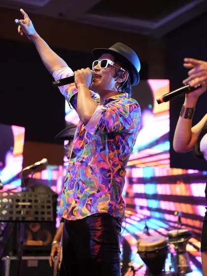 In the zone during a performance, pointing to the crowd. It's a two-way street; their energy fuels me, and I give it right back.