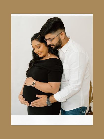 A close, intimate portrait that beautifully captures the feeling of "us". The focus is entirely on their connection and the baby they're waiting for.