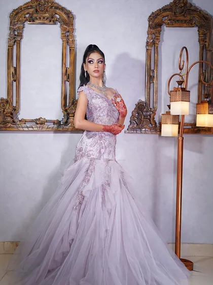 A side profile that highlights the gown's silhouette and the model's elegant updo.