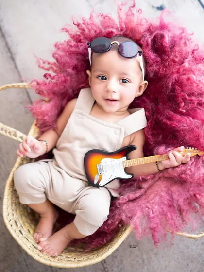 Awake and ready to rock! This little guy is all smiles with his mini guitar.