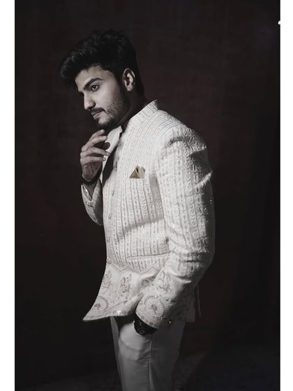 A black and white photo of the client in the embroidered off-white Jodhpuri, creating a timeless and artistic feel.