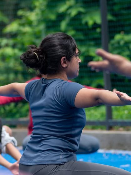 A participant focuses on her form during a mobility drill. The StrongHER series is designed to help women move with more intention and a deeper understanding of their physiology.