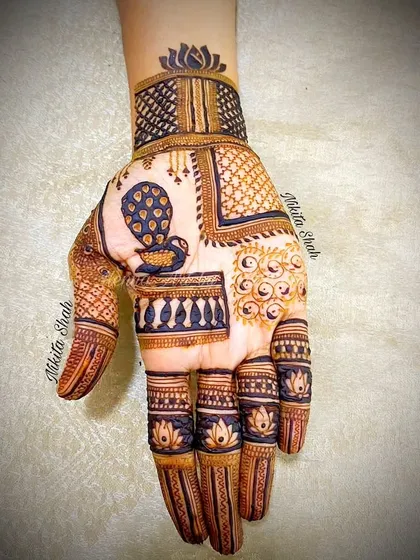 A trendy Indo-Western design with a patchwork feel. It combines different patterns like peacocks, checks, and florals in separate blocks for a very modern look.