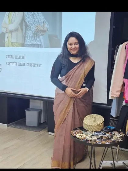 Standing by the tools of my trade: a presentation on image consulting and a table of accessories. My workshops are designed to be practical and visually engaging.